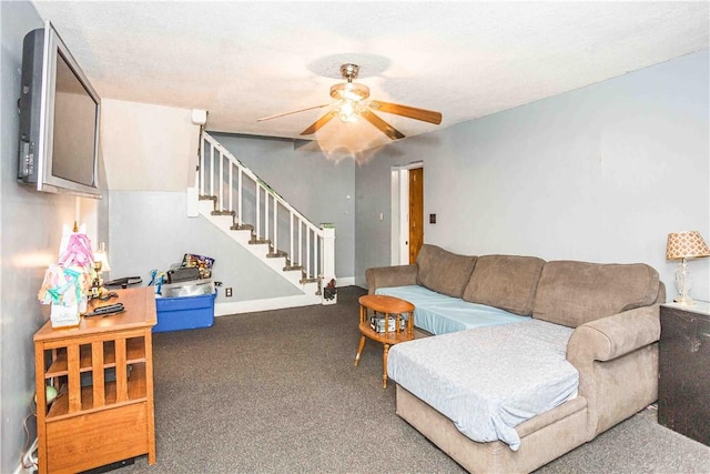 carpeted living area featuring ceiling fan, stairway, and baseboards