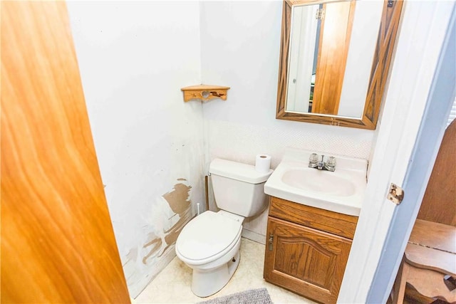 bathroom featuring toilet and vanity