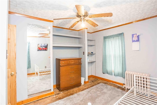 unfurnished bedroom featuring radiator, baseboards, ornamental molding, and ceiling fan