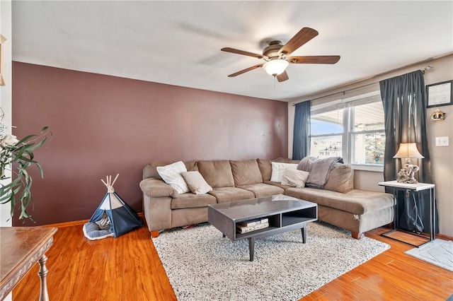 living room featuring ceiling fan and wood finished floors