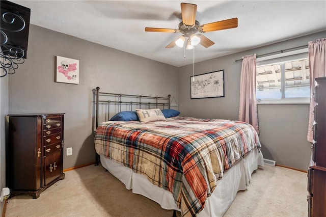 bedroom featuring light colored carpet, ceiling fan, and baseboards