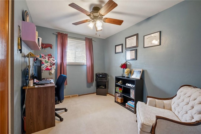 home office featuring baseboards, a ceiling fan, and carpet flooring