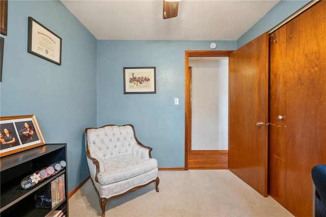 sitting room with carpet flooring and baseboards