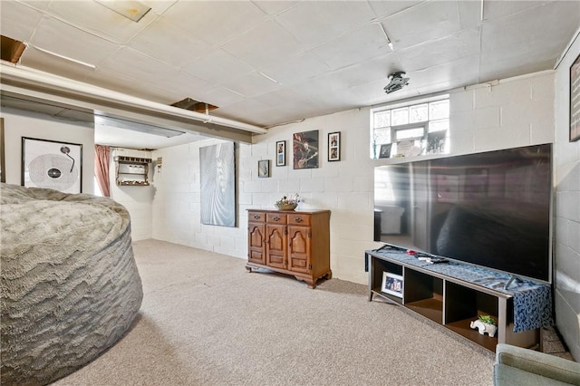 carpeted living room featuring a wall unit AC