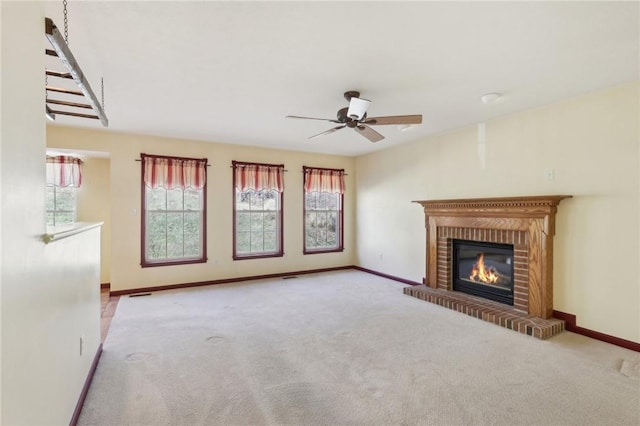 unfurnished living room featuring a fireplace, carpet flooring, and baseboards