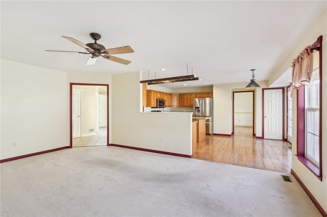 unfurnished living room with baseboards, visible vents, a ceiling fan, light colored carpet, and recessed lighting