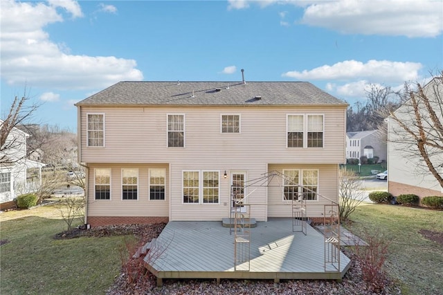 back of property with a lawn and a wooden deck