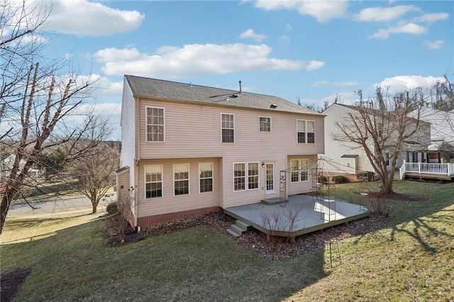 rear view of property featuring a yard and a wooden deck