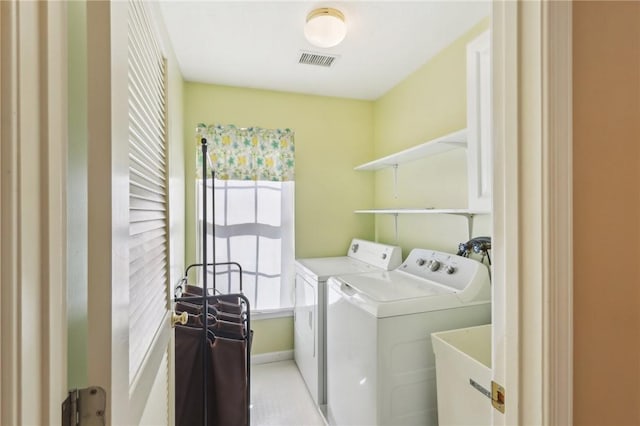 laundry area featuring a sink, laundry area, washing machine and clothes dryer, and visible vents