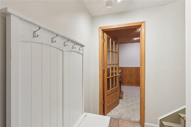 mudroom with wood walls