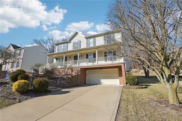 view of front facade featuring covered porch, brick siding, an attached garage, and concrete driveway