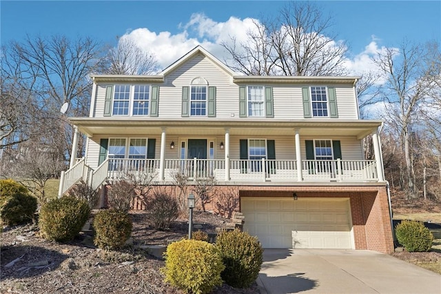 view of front of house with covered porch, a garage, brick siding, concrete driveway, and stairway