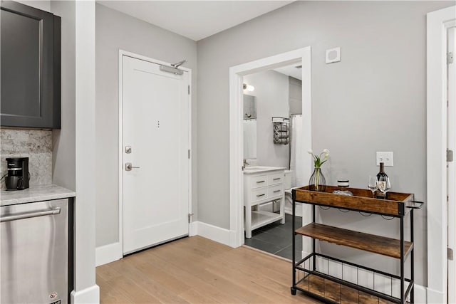 foyer entrance featuring light wood-style floors and baseboards