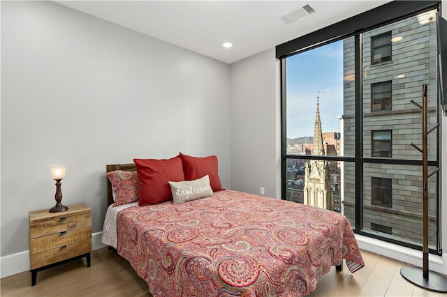 bedroom featuring recessed lighting, visible vents, and wood finished floors