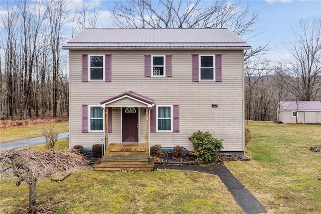 colonial home with metal roof and a front lawn