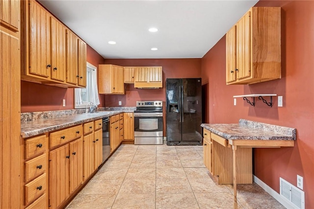 kitchen featuring light tile patterned flooring, a sink, visible vents, baseboards, and black appliances