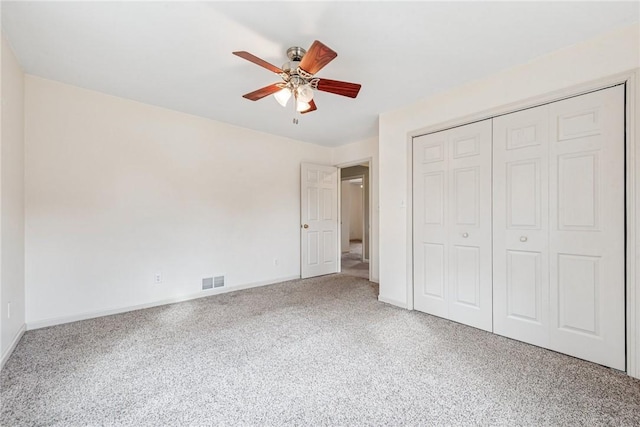 unfurnished bedroom featuring a closet, carpet flooring, visible vents, and baseboards