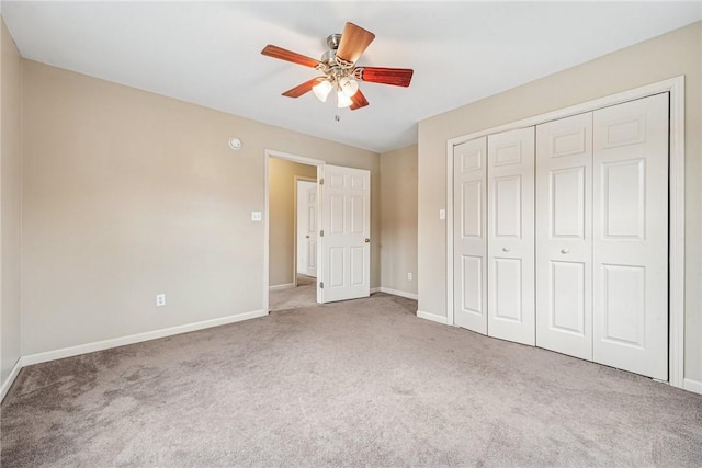 unfurnished bedroom with a closet, carpet, a ceiling fan, and baseboards