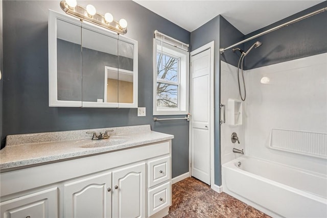 full bath with vanity, baseboards, and shower / bathtub combination