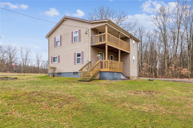 rear view of property featuring a balcony and a yard