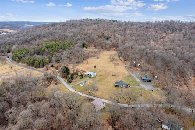 aerial view featuring a wooded view and a rural view