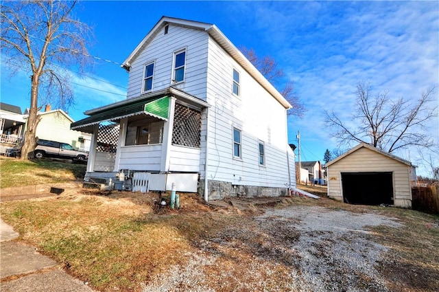 view of front facade with a garage, driveway, and an outdoor structure