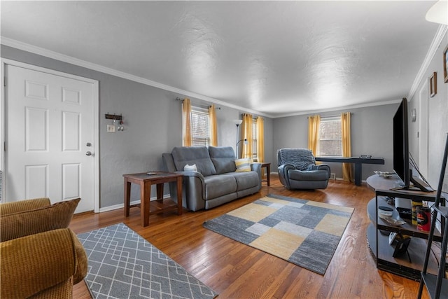 living room with baseboards, ornamental molding, a wealth of natural light, and wood finished floors