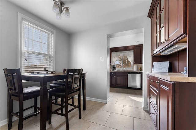 dining area with light tile patterned flooring and baseboards