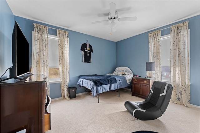 bedroom with a ceiling fan, carpet, and baseboards