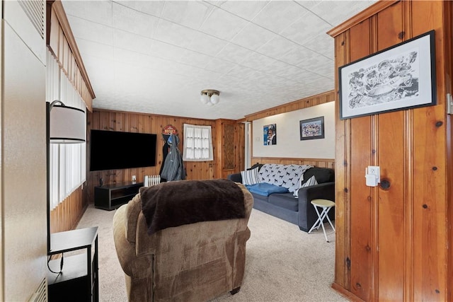 living area featuring light carpet, radiator heating unit, and wood walls