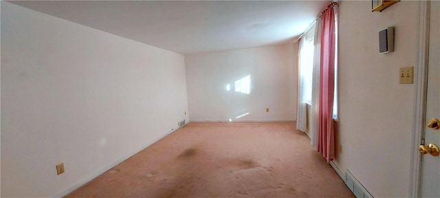 unfurnished room with light colored carpet and visible vents