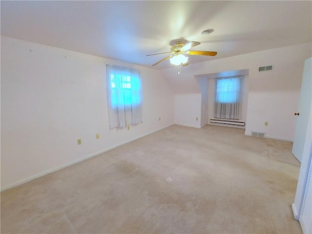 bonus room with a baseboard radiator, visible vents, ceiling fan, and light colored carpet