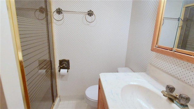 bathroom featuring wallpapered walls, a shower stall, toilet, and vanity