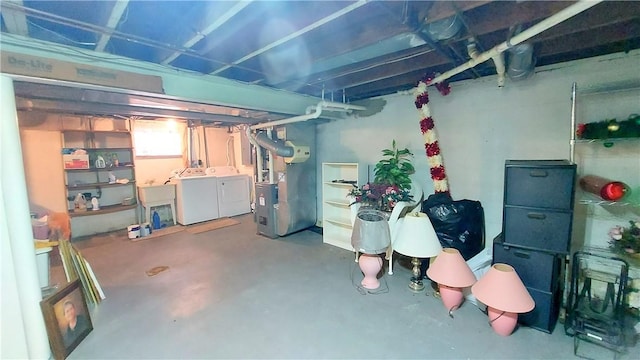 below grade area featuring separate washer and dryer, a sink, and heating unit