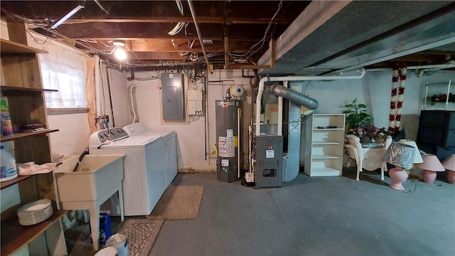 below grade area featuring washer and dryer, gas water heater, electric panel, and heating unit