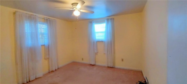 unfurnished room with light carpet, ceiling fan, and baseboards