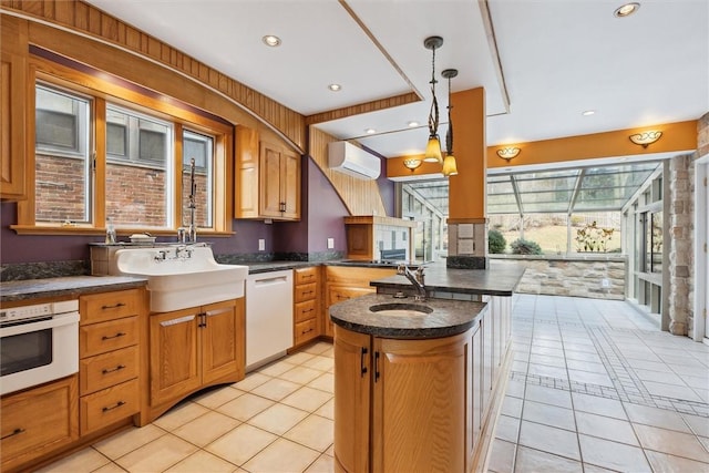 kitchen featuring white appliances, light tile patterned floors, plenty of natural light, and a wall mounted air conditioner