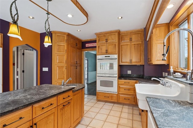 kitchen with a sink, decorative light fixtures, recessed lighting, double oven, and light tile patterned floors