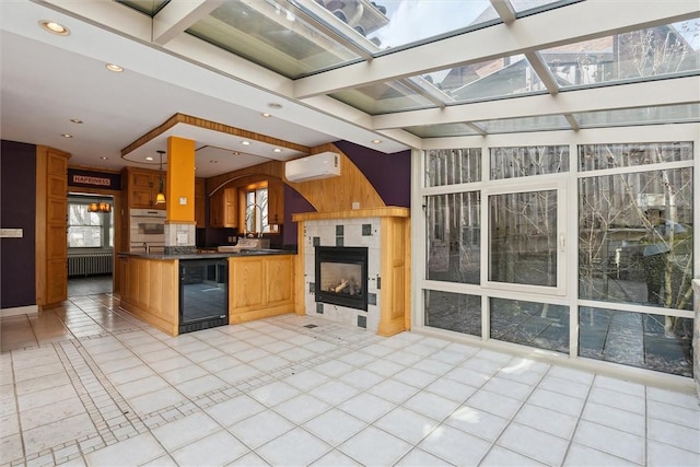 kitchen with oven, a wall mounted air conditioner, dark countertops, wine cooler, and a fireplace