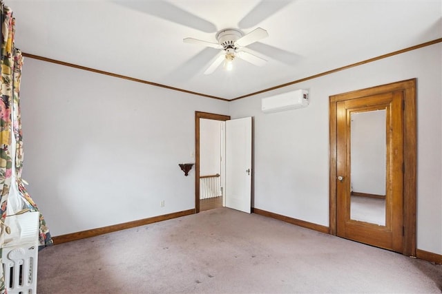 carpeted empty room with crown molding, a ceiling fan, baseboards, and a wall mounted air conditioner