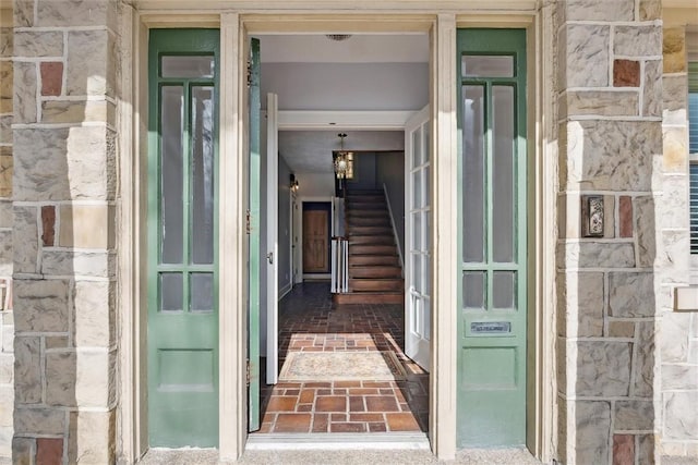 doorway to property with stone siding