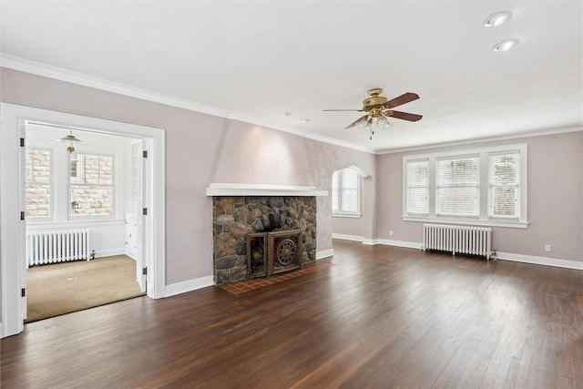 unfurnished living room featuring dark wood finished floors, crown molding, and radiator