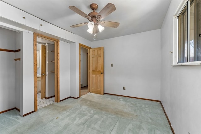 unfurnished bedroom featuring light carpet, ceiling fan, and baseboards