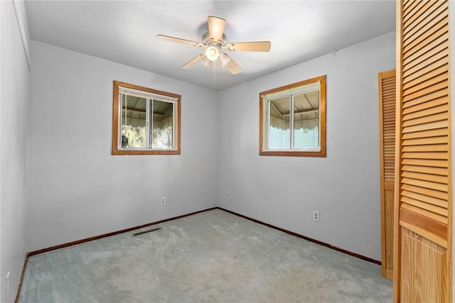 unfurnished bedroom with carpet, multiple windows, baseboards, and a closet