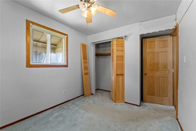 unfurnished bedroom featuring a closet, light carpet, ceiling fan, and baseboards