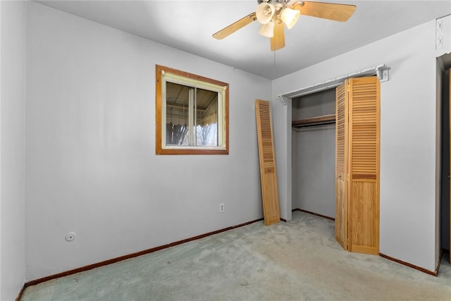 unfurnished bedroom with ceiling fan, a closet, carpet flooring, and baseboards