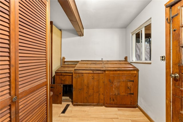 interior space with baseboards and wood finished floors