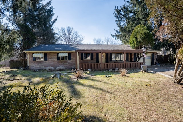 ranch-style house with a garage, stone siding, a front yard, and driveway