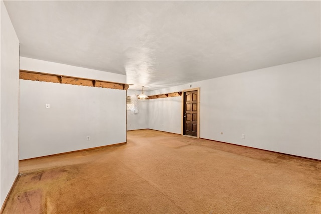 unfurnished room with light carpet and baseboards