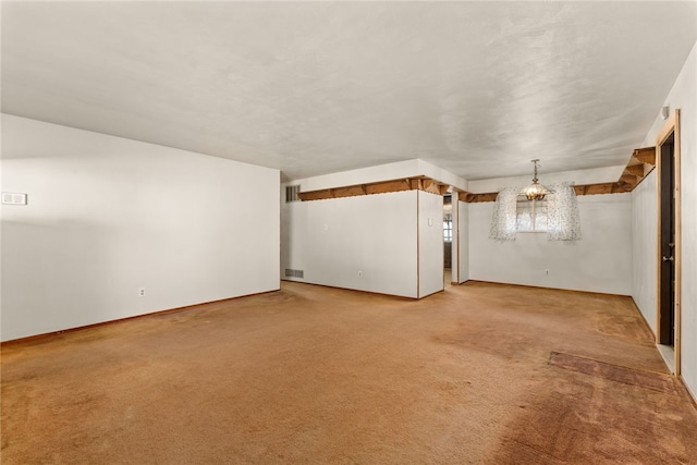 unfurnished living room featuring light colored carpet and visible vents